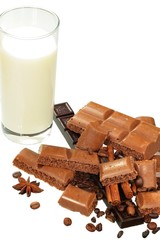 Chocolate, spices and glass of milk on white background