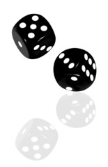 Black and white dice reflected on a white surface.