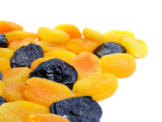 Dried apricot and black plum fruits isolated over white