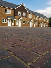 Row of new terraced houses with cobbled paviors