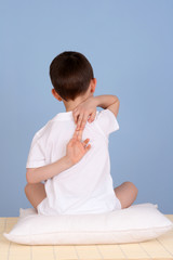 6 years old boy relaxing on blue background