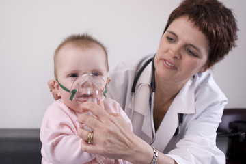 Seven month old baby with a nebulizer mask.