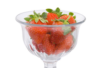 A cut glass bowl filled with fresh ripe strawberries