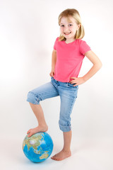 Girl with her foot on top of a globe