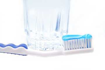 Toothbrush with toothpaste, glass of water and tube