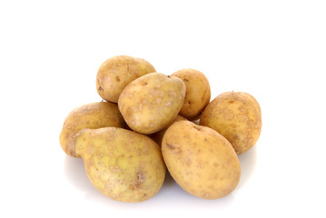 Fresh potato on reflective surface, studio shot, 