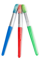 The tips of three colorful paintbrushes ready to be used.