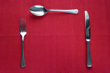 fork, knife and spoon with copy space in the place of the plate