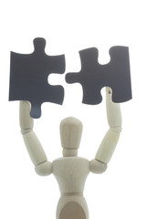 Manikin joins two black puzzle pieces