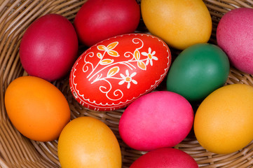 Fototapeta na wymiar Colorful Easter eggs in straw basket