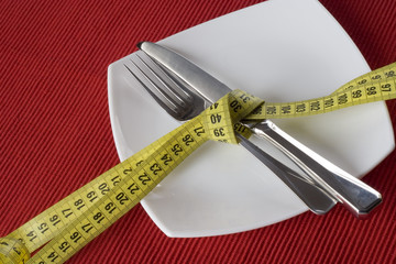 Fork and knife tieup with a measure tape. 