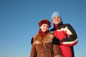 couple against blue sky background in winter 2