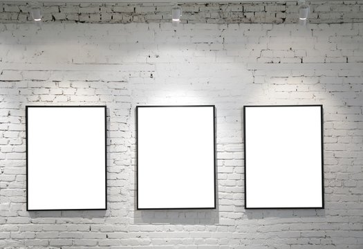 three frames on brick wall