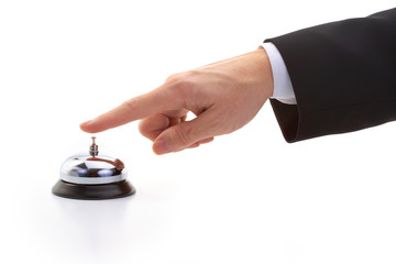 finger of businessman ringing reception bell