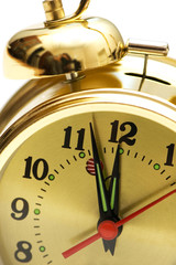 Golden alarm clock isolated on the white