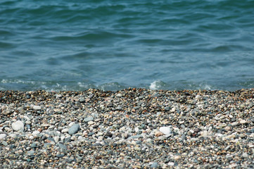 Fototapeta na wymiar Water and small pebbles at the beach
