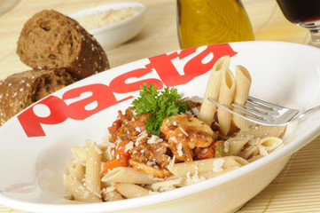 a plate with whole-wheat pasta and bolognese sauce