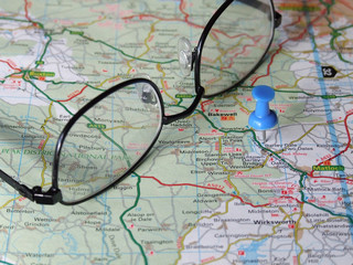 Glasses on a pin-pointed map