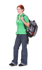 Fototapeta premium Redheaded teenage backpacker against a white background.