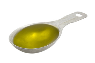 Measuring tablespoon of olive oil isolated on white - obrazy, fototapety, plakaty