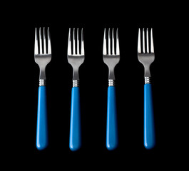 four forks in raw over black