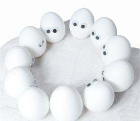 Eggs with eyes standing in a circle. Add your own expessions.