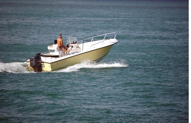 Naklejka premium Yellow Outboard Motor Boat