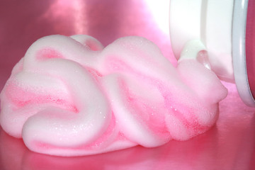 bottle with shaving cream on pink background