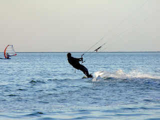 Silhouette of a kite-surf on waves of a gulf 1