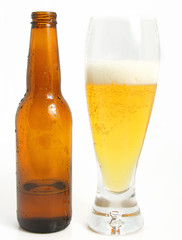 glass of beer and bottle over white background