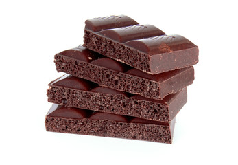Black chocolate blocks isolated on white background
