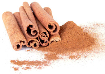 Cinnamon powder and sticks on white backhround