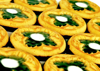 Background from chocolate cookies with green clover symbols