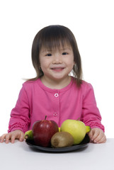 Fototapeta premium A young girl with a plate full of fruits.
