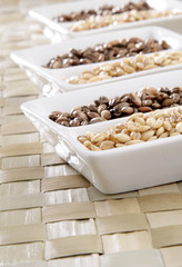 Several bowls of organic raw and roasted barley.