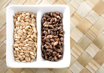 A bowl of organic raw and roasted barley.