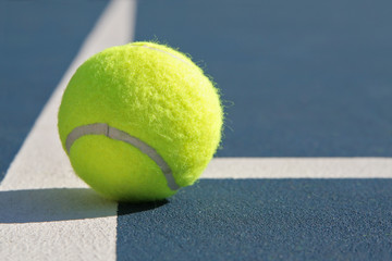 Tennis Ball on Blue Court