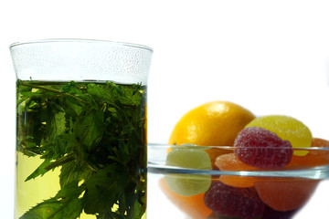 herbal  mint tea and  fruit candy on white background