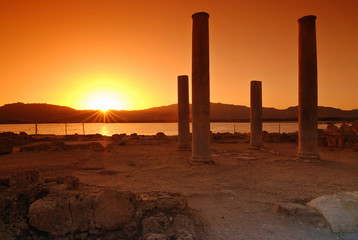 Sunset and pilars of ruins on Sardinian town of Nora