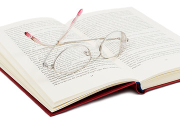 open book with glasses on it