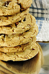 Stack of fresh chocolate chip cookies on a metal dish.