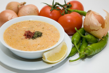 cream soup with vegetables on white background