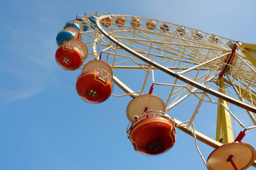 Closeup of ferris wheel chairs against the sky