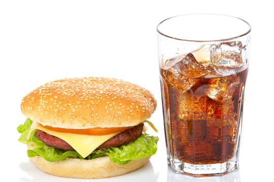 Hamburger and soda, reflected on white background. Shallow DOF