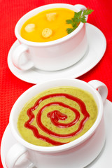 Spinach and carrots puree on red mat. Shallow DOF