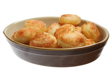 Roast potatoes in an earthware serving dish