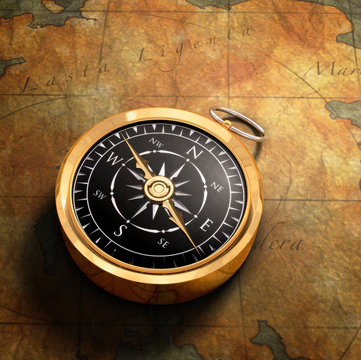 An old fashoned brass compass on a Treasure map background