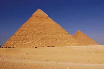 Pyramids of Giza in Egypt against a blue sky