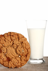 milk glass with toffee pecan cookie on burlap canvas