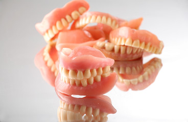 group of artificial dentures on reflecting background